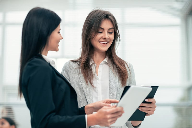 Woman checking her employee's finished paperwork