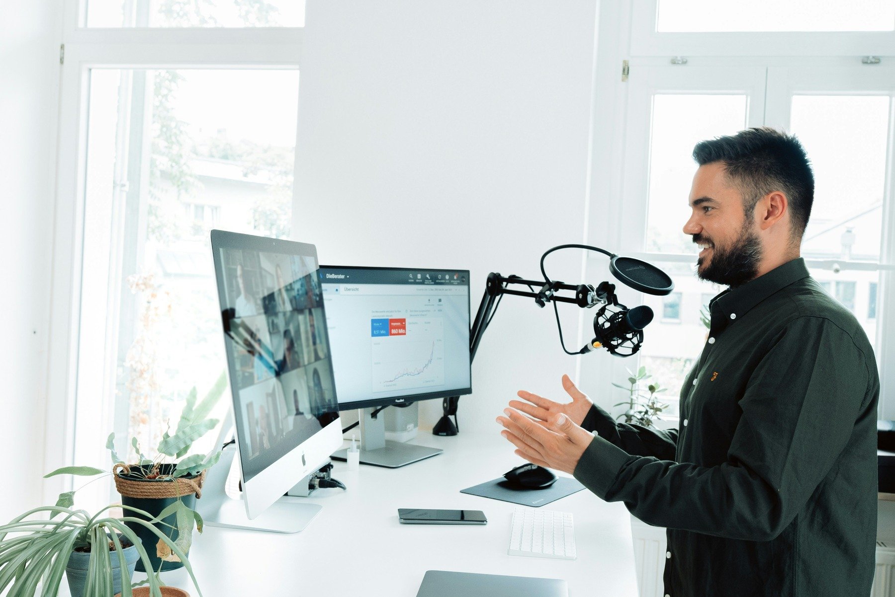 Man talking on a Zoom meeting on his desktop setup