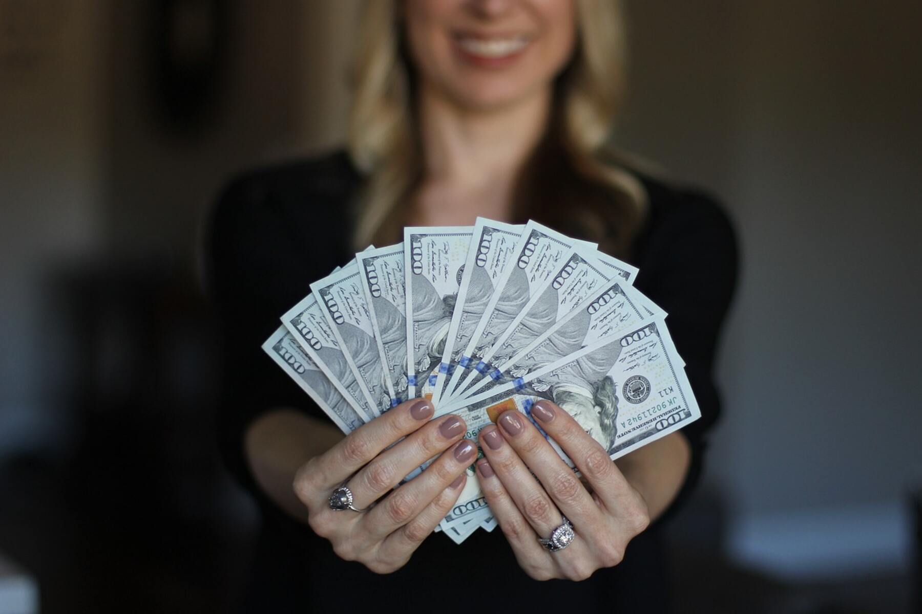 A woman showing money on her hands
