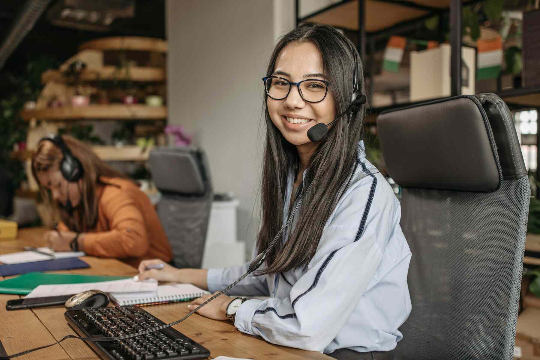A woman working with her headphones on