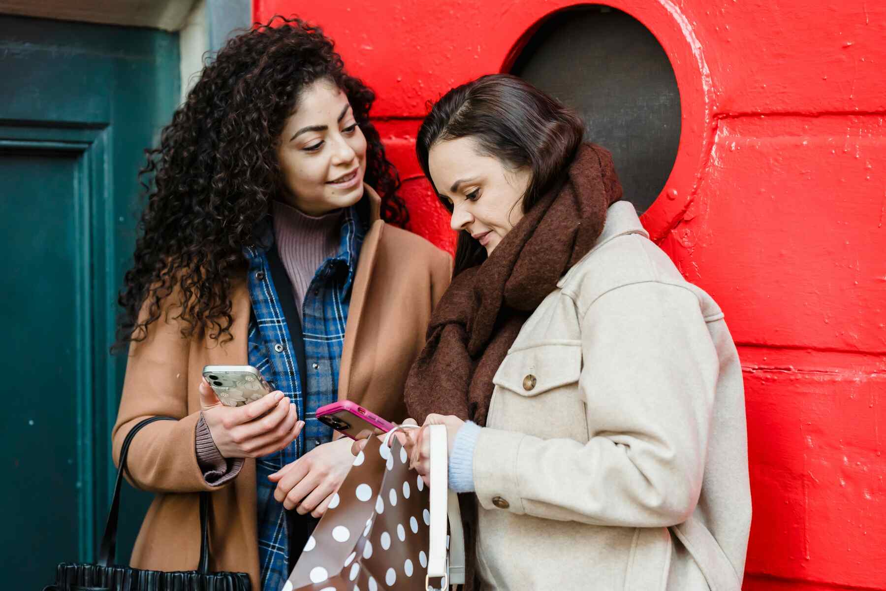 Two women using their phones