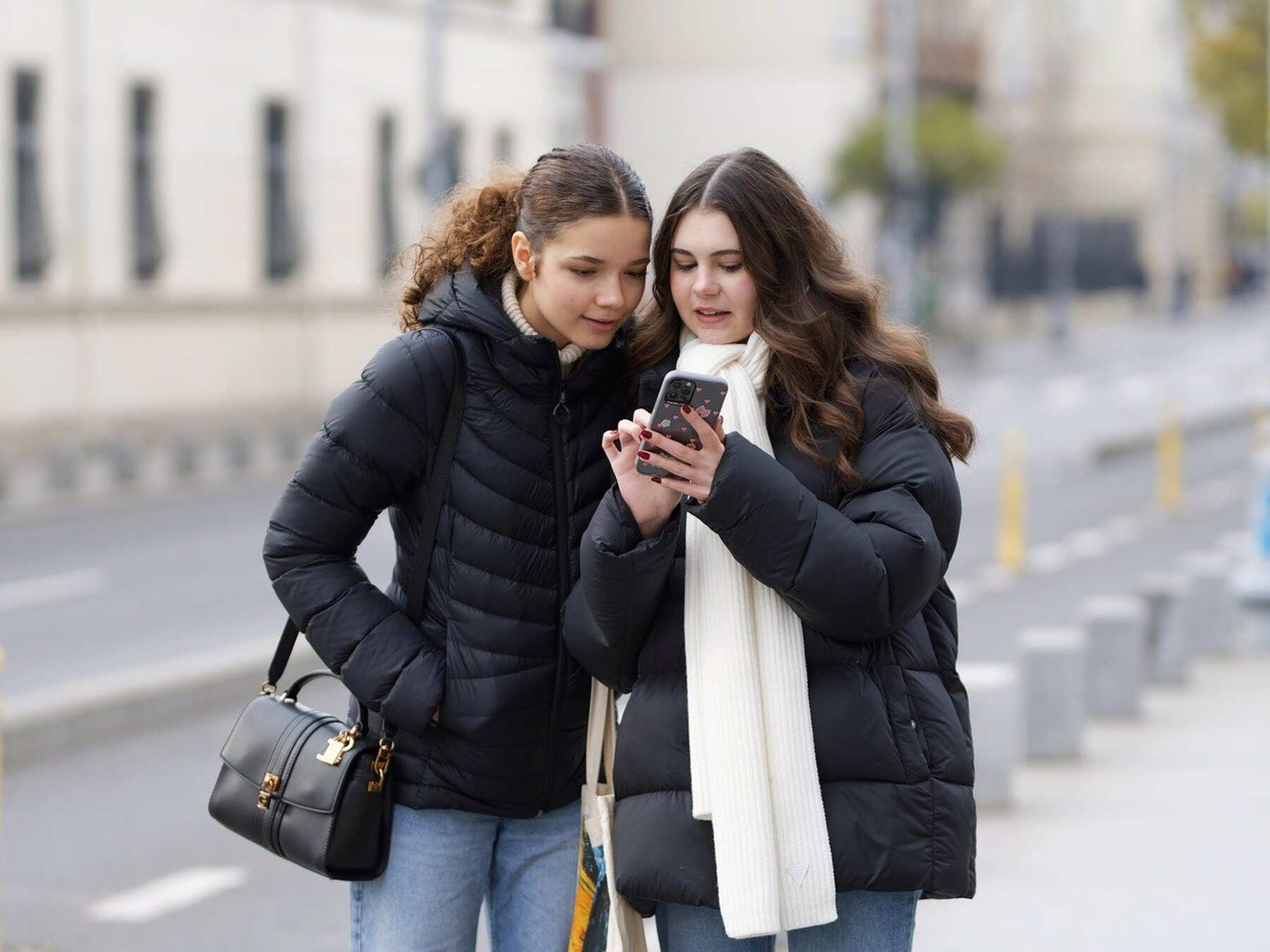 Two women busy looking at the phone