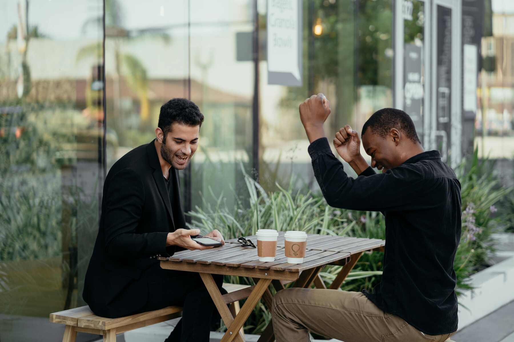 Two men sitting outside the coffee shop