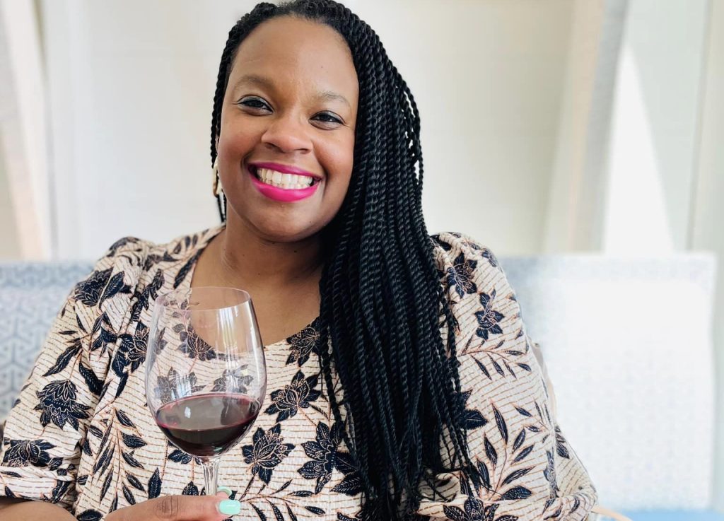 a woman seated with a wine glass