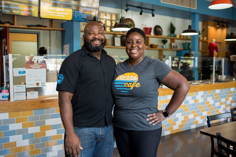 two people pose in a restaurant