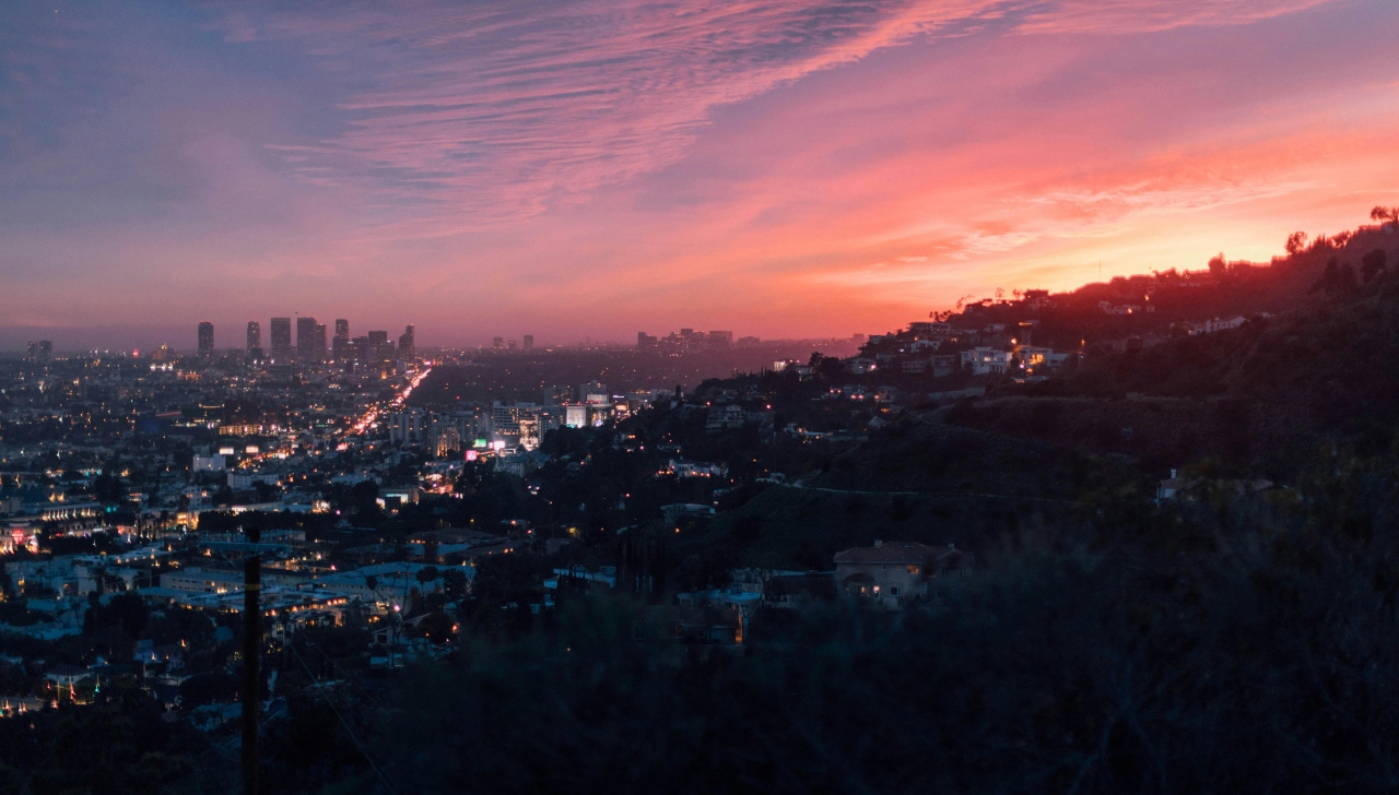 city of los angeles in distance with sunsetting