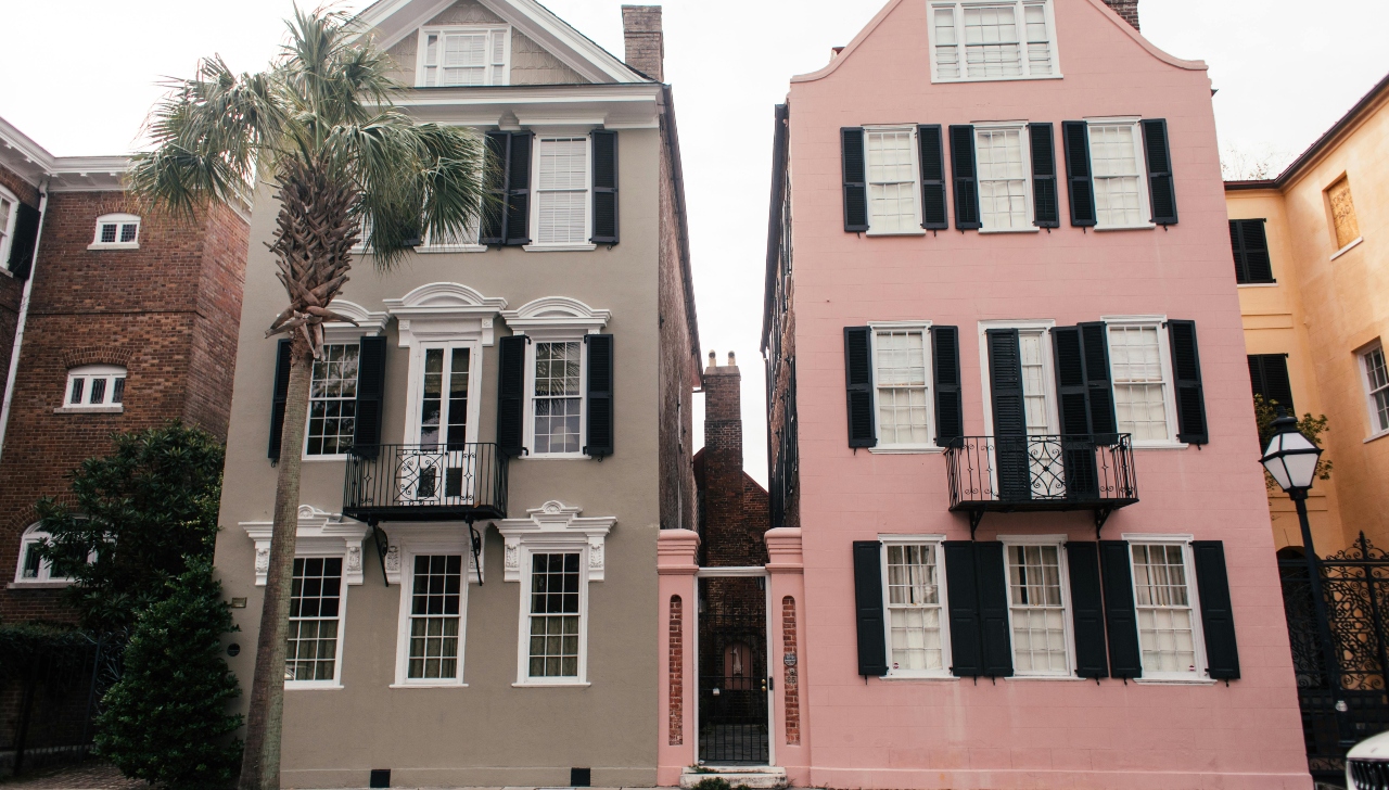 two row houses, one pink and one grey